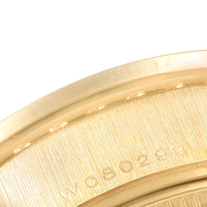 The image shows a close-up view of the edge and back of the Rolex President 69138 Women
s Yellow Gold Mother of Pearl Dial 69138 Women
s Yellow Gold Mother of Pearl Dial model watch, featuring part of the serial number.