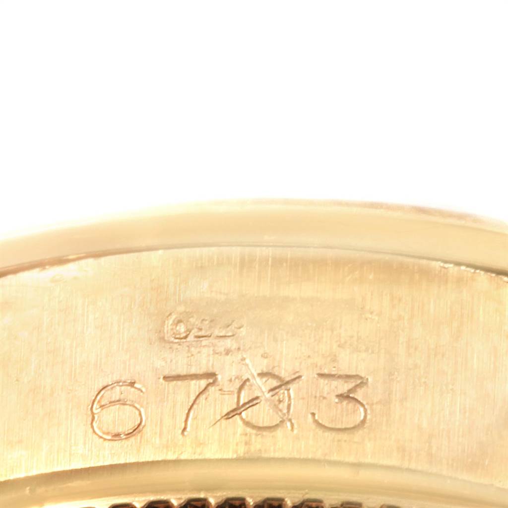 The image shows a close-up of the serial number engraved on the band of a Rolex President 6703 Women's Yellow Gold Champagne Dial 6703 Women's Yellow Gold Champagne Dial model watch.