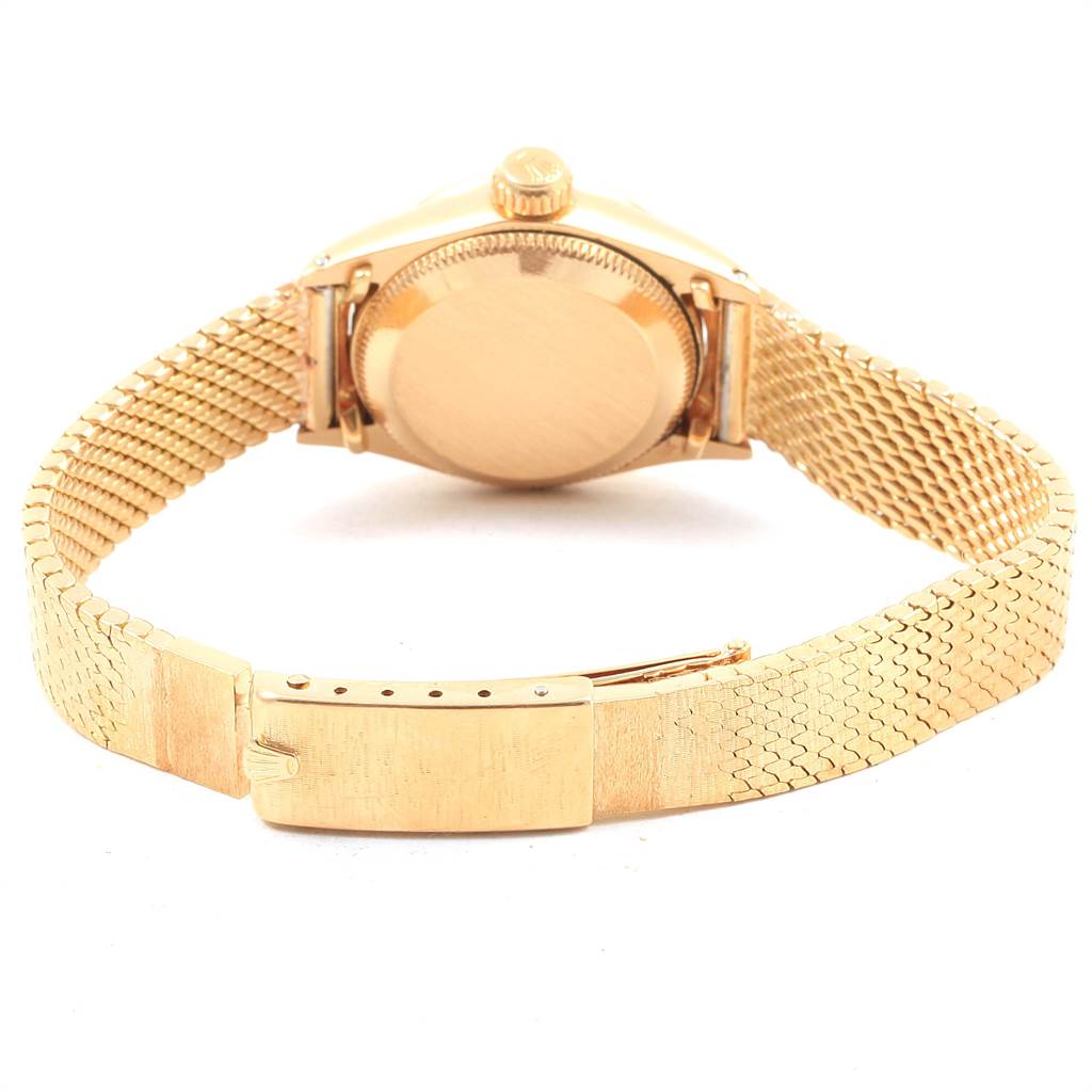 The image shows the back view of a Rolex President 6703 Women's Yellow Gold Champagne Dial 6703 Women's Yellow Gold Champagne Dial model watch, highlighting its case back, crown, and gold bracelet.