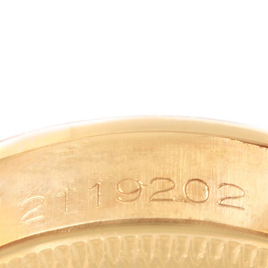 This close-up image shows the serial number engraved on the case of a Rolex President 6703 Women's Yellow Gold Champagne Dial 6703 Women's Yellow Gold Champagne Dial model watch.