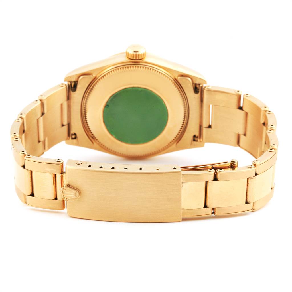 The image shows the back view of a Rolex President 68278 Women
s Yellow Gold Champagne Dial 68278 Women
s Yellow Gold Champagne Dial model watch, highlighting its gold bracelet and clasp.