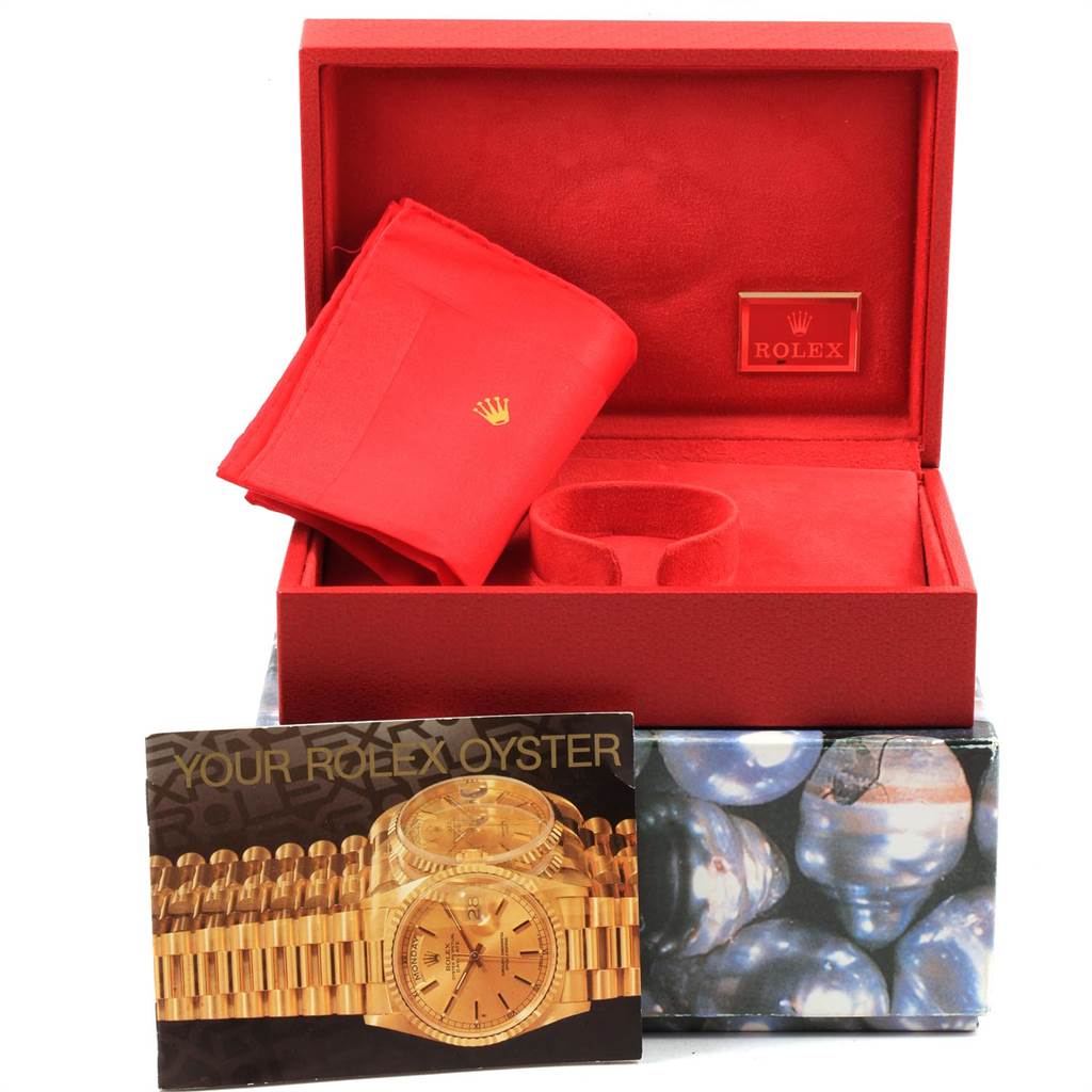 This image shows the packaging, cleaning cloth, and booklet for the Rolex President 68278 Women
s Yellow Gold Champagne Dial 68278 Women
s Yellow Gold Champagne Dial model watch.