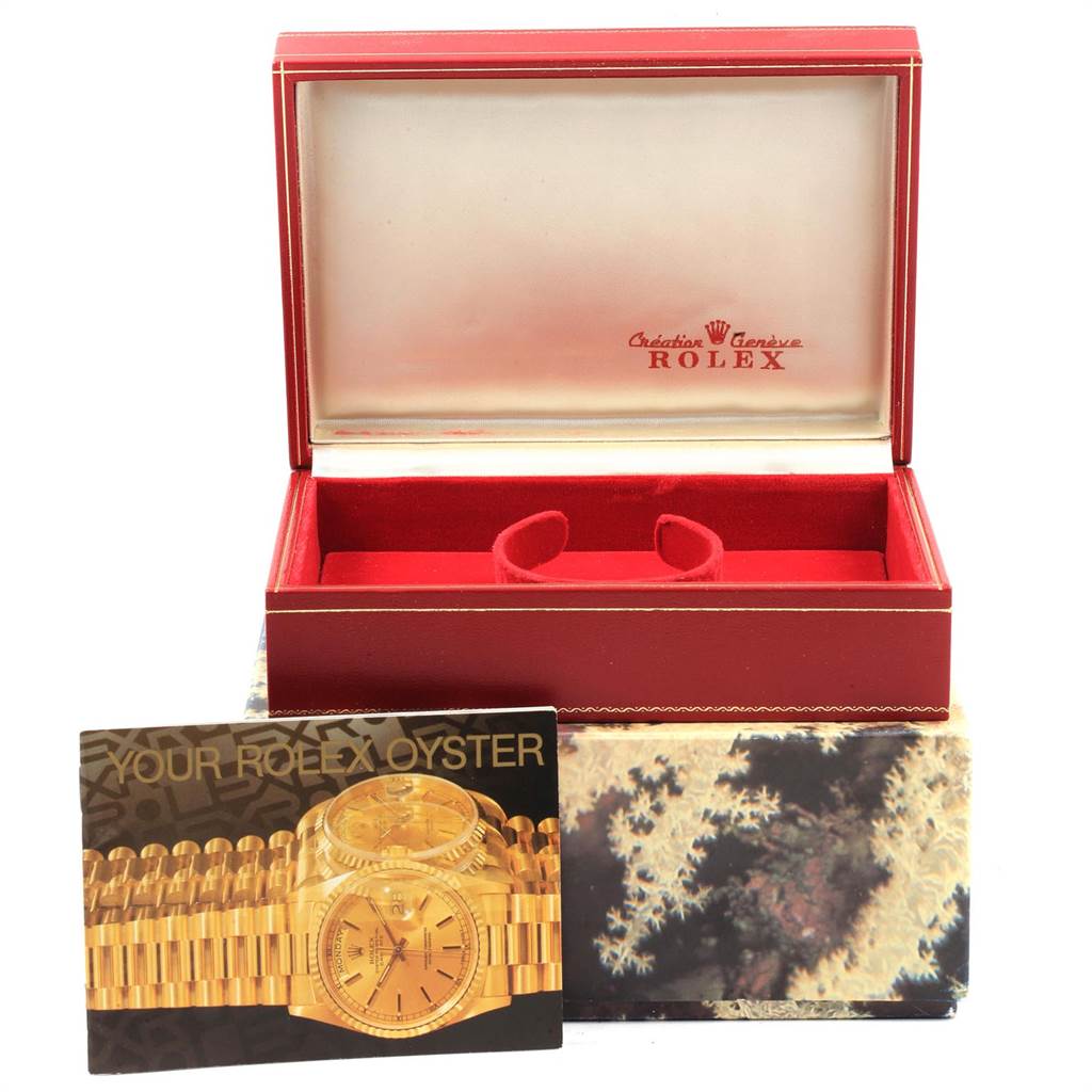 This image shows the open box and booklet for the Rolex President 69178 Women
s Yellow Gold White Dial 69178 Women
s Yellow Gold White Dial model watch, without the watch itself.