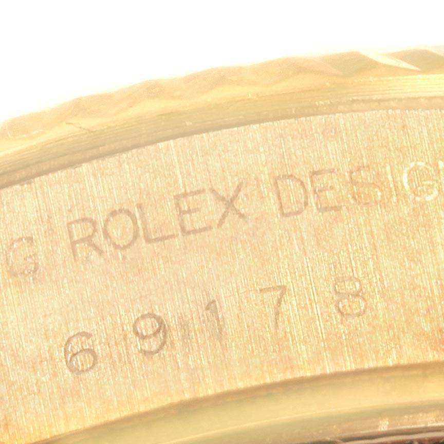 This close-up image shows the engraving on the inner side of the case of a Rolex President 69178 Women
s Yellow Gold White Dial 69178 Women
s Yellow Gold White Dial model watch.