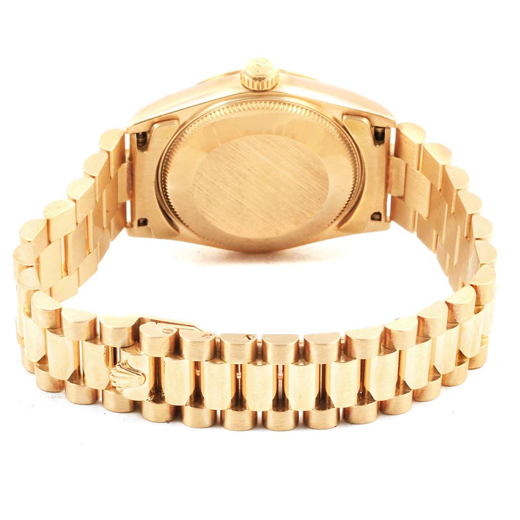 The image shows the back view of a Rolex President 68278 Women
s Yellow Gold Champagne Dial 68278 Women
s Yellow Gold Champagne Dial model watch, focusing on the case back and bracelet.