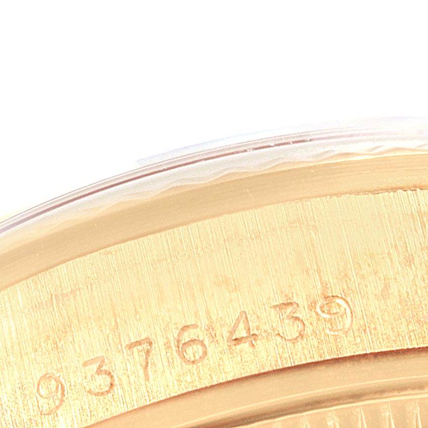 The image shows a close-up of part of the bezel and caseback edge of a Rolex President 68278 Women
s Yellow Gold Champagne Dial 68278 Women
s Yellow Gold Champagne Dial watch, revealing its serial number.