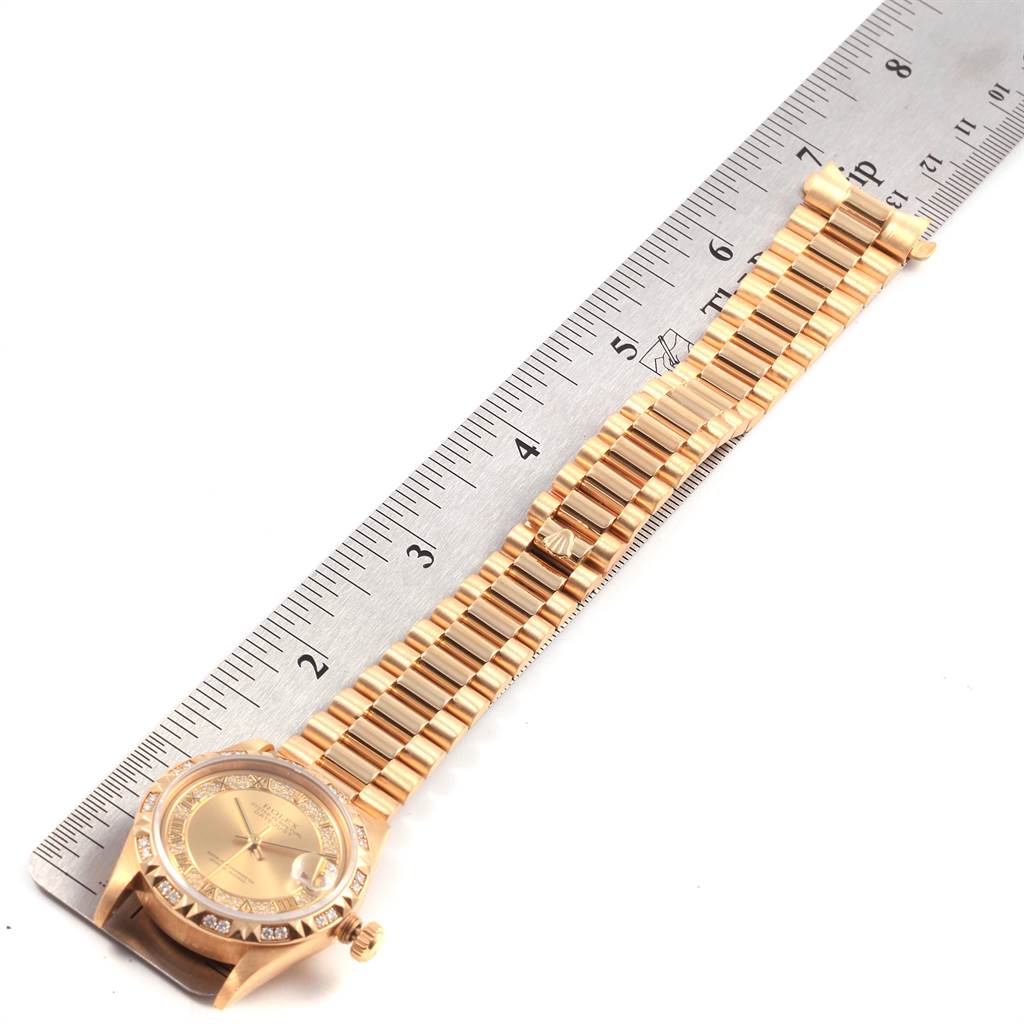 The Rolex President 68258 Women
s Yellow Gold Champagne Dial 68258 Women
s Yellow Gold Champagne Dial model watch is shown at a slight angle, displaying its gold bracelet and bezel next to a ruler.