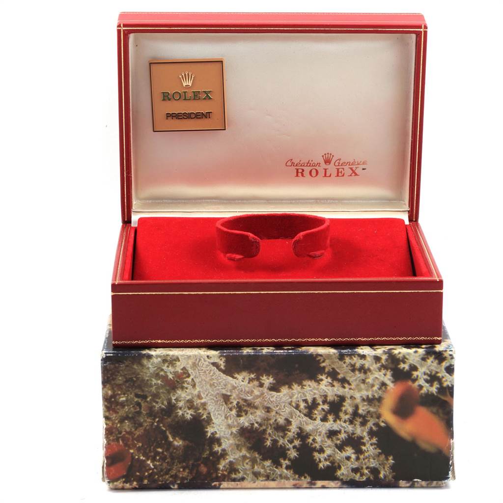 This image shows the luxury case for a Rolex President 68258 Women
s Yellow Gold Champagne Dial 68258 Women
s Yellow Gold Champagne Dial model watch, featuring a red interior and distinctive branding.