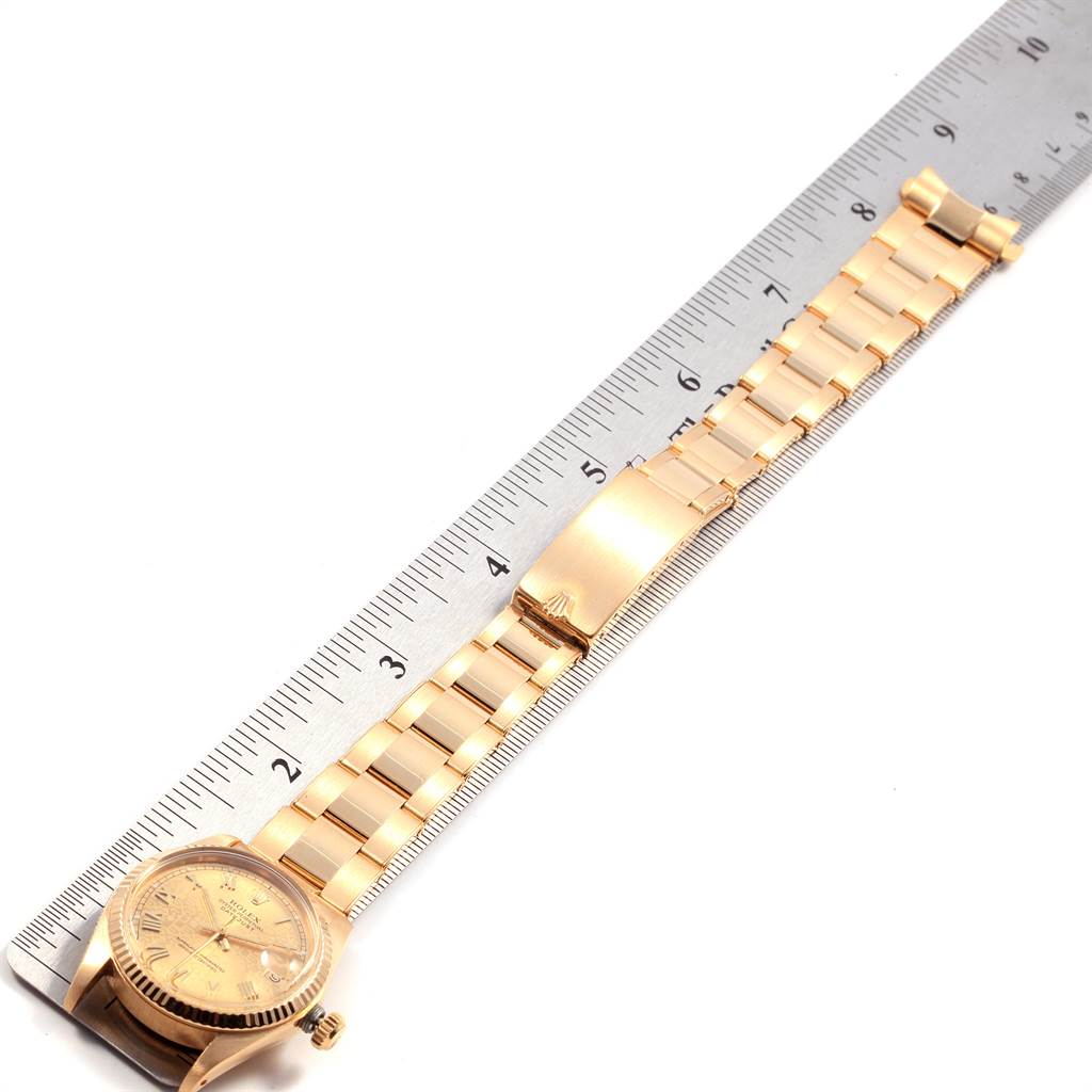 The image shows a Rolex President 6827 Women
s Yellow Gold Champagne Dial 6827 Women
s Yellow Gold Champagne Dial model watch laid out flat with a ruler for scale.