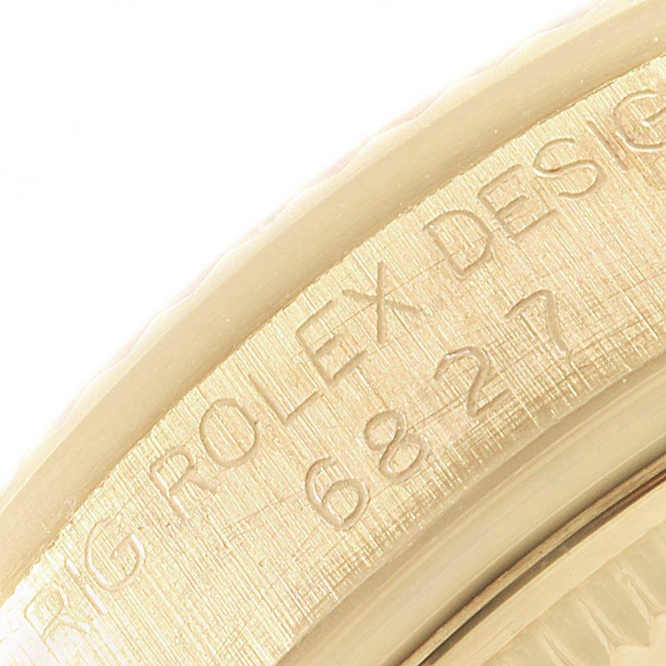 The image shows a close-up of the engraved inner bezel of the Rolex President 6827 Women
s Yellow Gold Champagne Dial 6827 Women
s Yellow Gold Champagne Dial model watch.