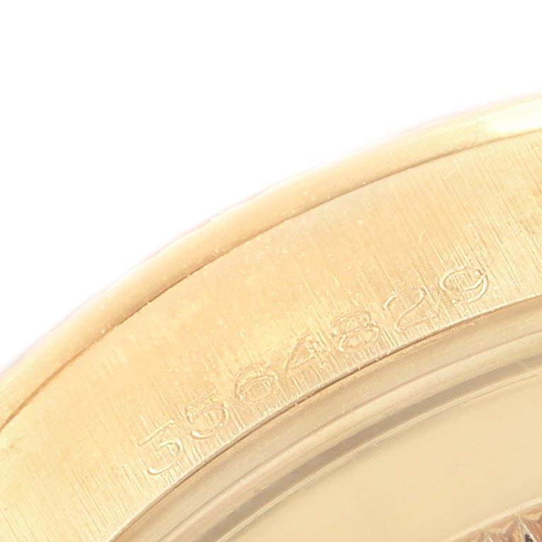 Close-up view of the Rolex President 6827 Women
s Yellow Gold Champagne Dial 6827 Women
s Yellow Gold Champagne Dial model showing part of the bezel with engraved serial numbers.