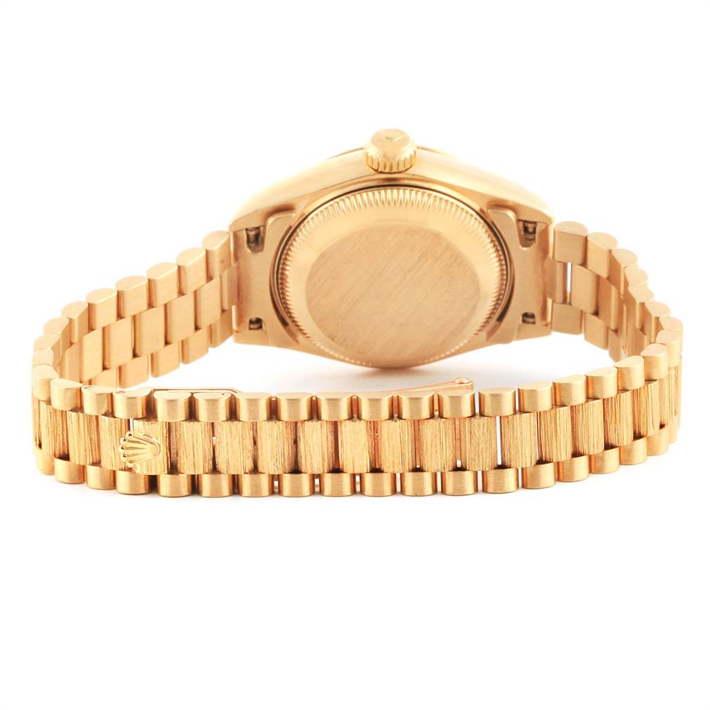 The image shows the back case and part of the bracelet of a Rolex President 69278 Women
s Yellow Gold Champagne Dial 69278 Women
s Yellow Gold Champagne Dial model watch.