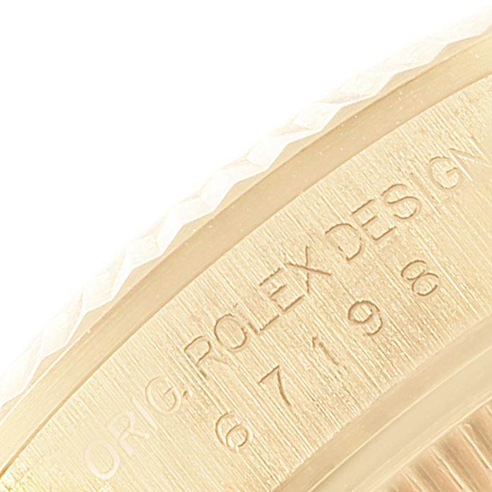 This image shows a close-up of the case side of the Rolex President 67198 Women
s Yellow Gold Black Dial 67198 Women
s Yellow Gold Black Dial model watch, highlighting the engraved brand and design details.