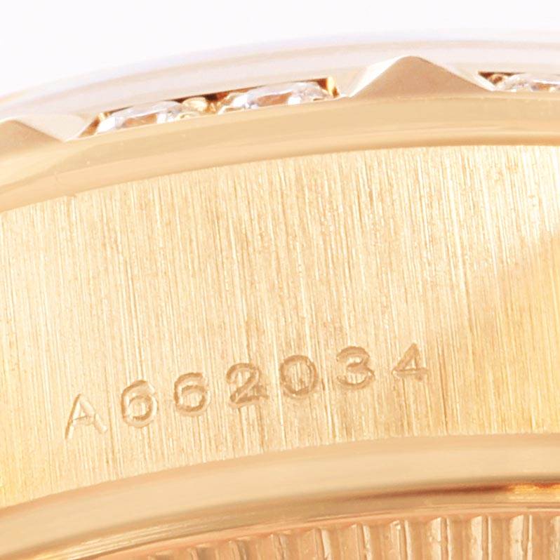 The image shows a close-up of the engraved serial number on the side of a Rolex President 79258 Women's Yellow Gold Beige Dial 79258 Women's Yellow Gold Beige Dial model watch case.
