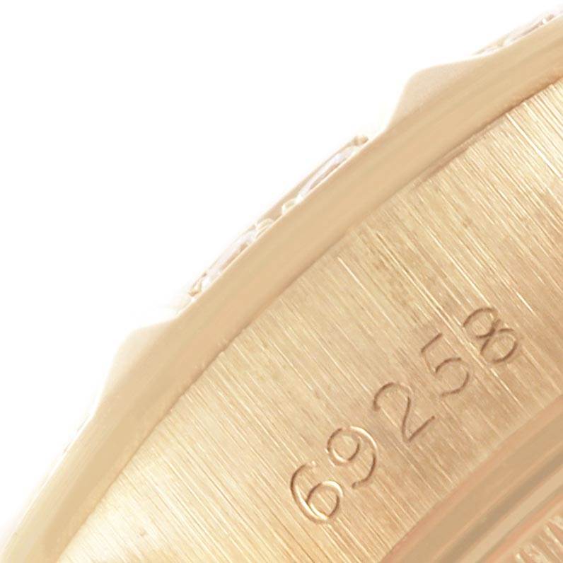The image shows a close-up angle of the outer edge of a Rolex President 69258 Women
s Yellow Gold White Dial 69258 Women
s Yellow Gold White Dial model, featuring part of the case with engraved numbers.