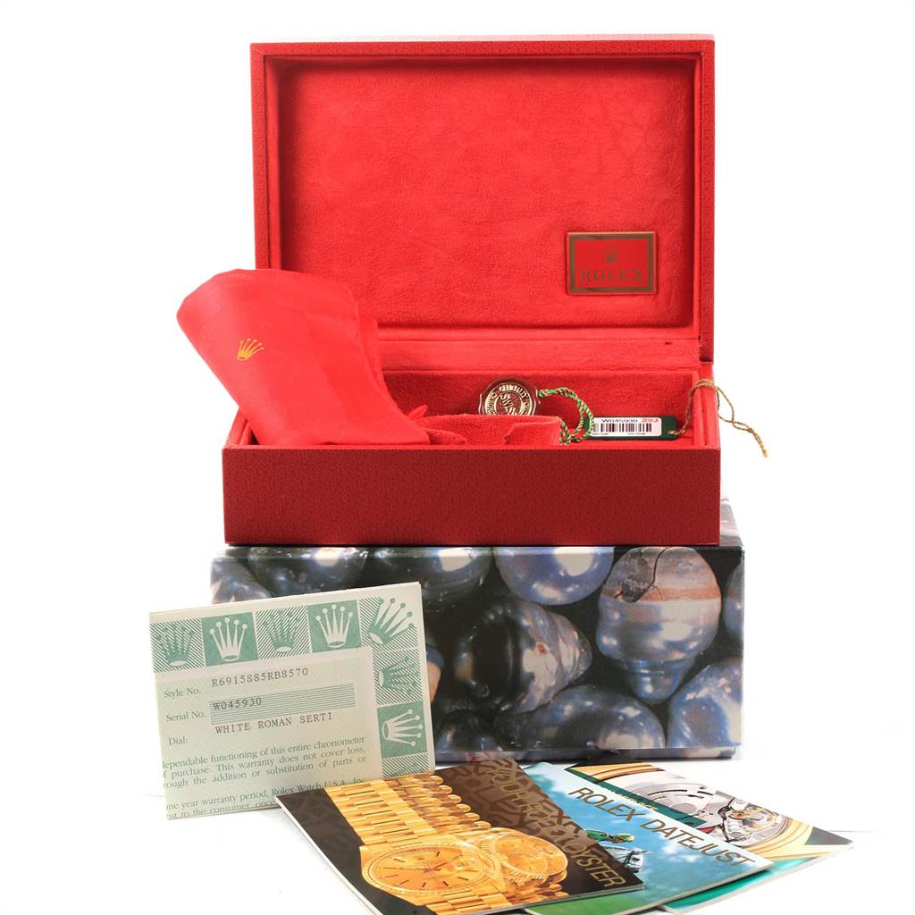 The image shows a Rolex President 69158 Women
s Yellow Gold White Dial 69158 Women
s Yellow Gold White Dial watch box at an angle, including the red case, registration card, and booklets.