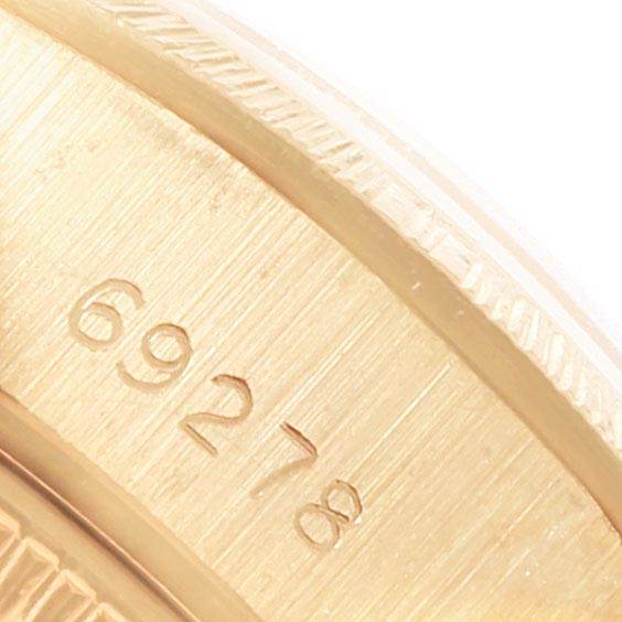 The image shows a close-up of the serial number on the case of a Rolex President 69278 Women
s Yellow Gold White Dial 69278 Women
s Yellow Gold White Dial model watch.