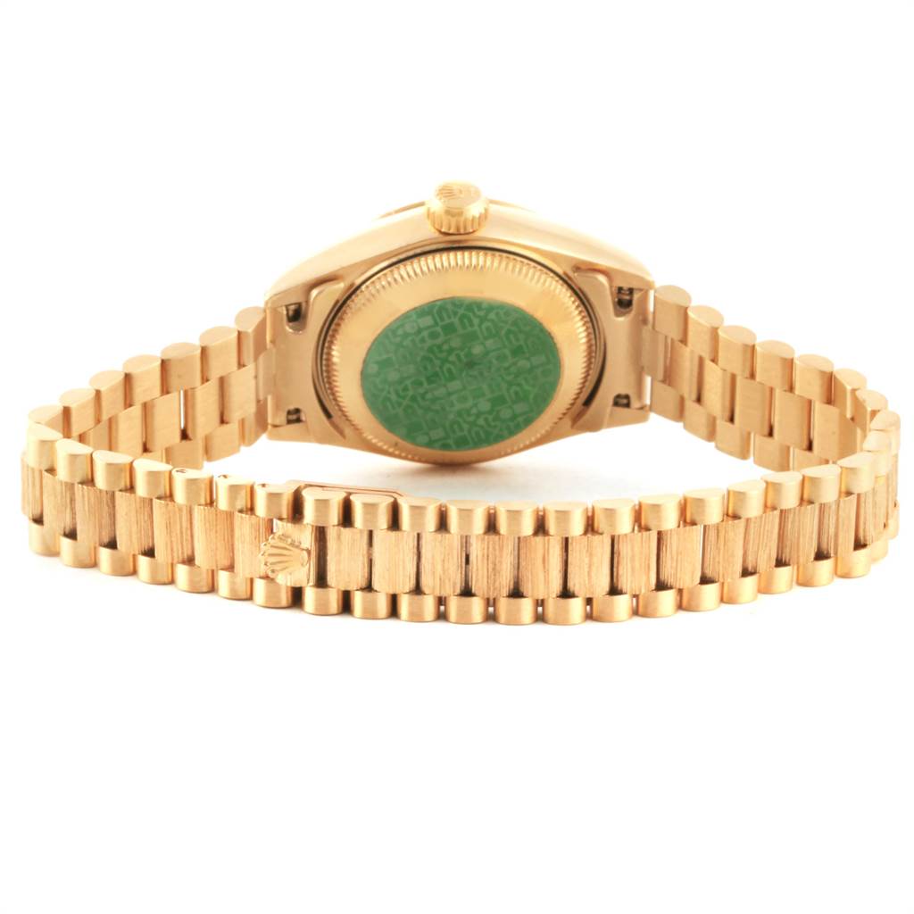 This image shows the underside of a Rolex President 69278 Women
s Yellow Gold White Dial 69278 Women
s Yellow Gold White Dial model watch, focusing on the case back and bracelet.