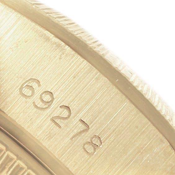 The image shows a close-up of the case and serial number of a Rolex President 69278 Women
s Yellow Gold Champagne Dial 69278 Women
s Yellow Gold Champagne Dial model watch.