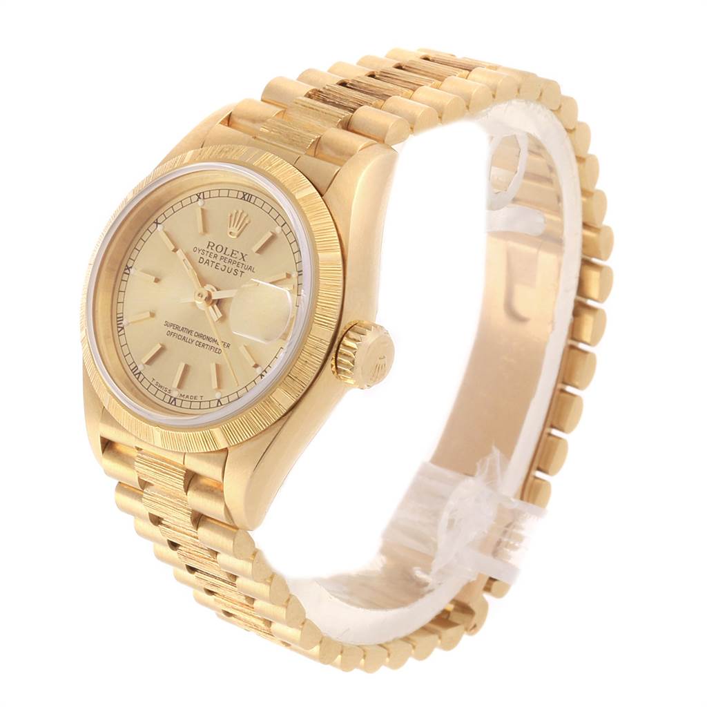 This image shows a gold-colored Rolex President 69278 Women
s Yellow Gold Champagne Dial 69278 Women
s Yellow Gold Champagne Dial model watch at a slight side angle, highlighting the face, bezel, and bracelet.
