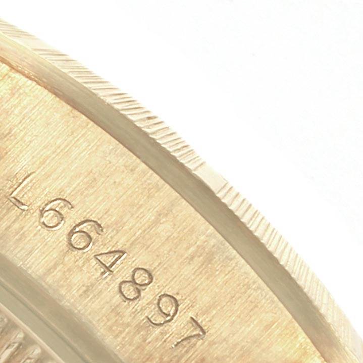 The image shows a close-up of the side of the caseback of a Rolex President 69278 Women
s Yellow Gold Champagne Dial 69278 Women
s Yellow Gold Champagne Dial model watch, focusing on the engraved serial number.