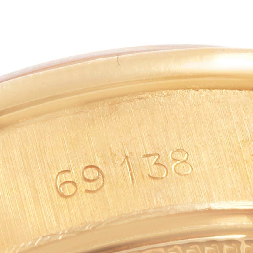 This close-up shows the model number engraving on the case back of the Rolex President 69138 Women's Yellow Gold Champagne Dial 69138 Women's Yellow Gold Champagne Dial watch.