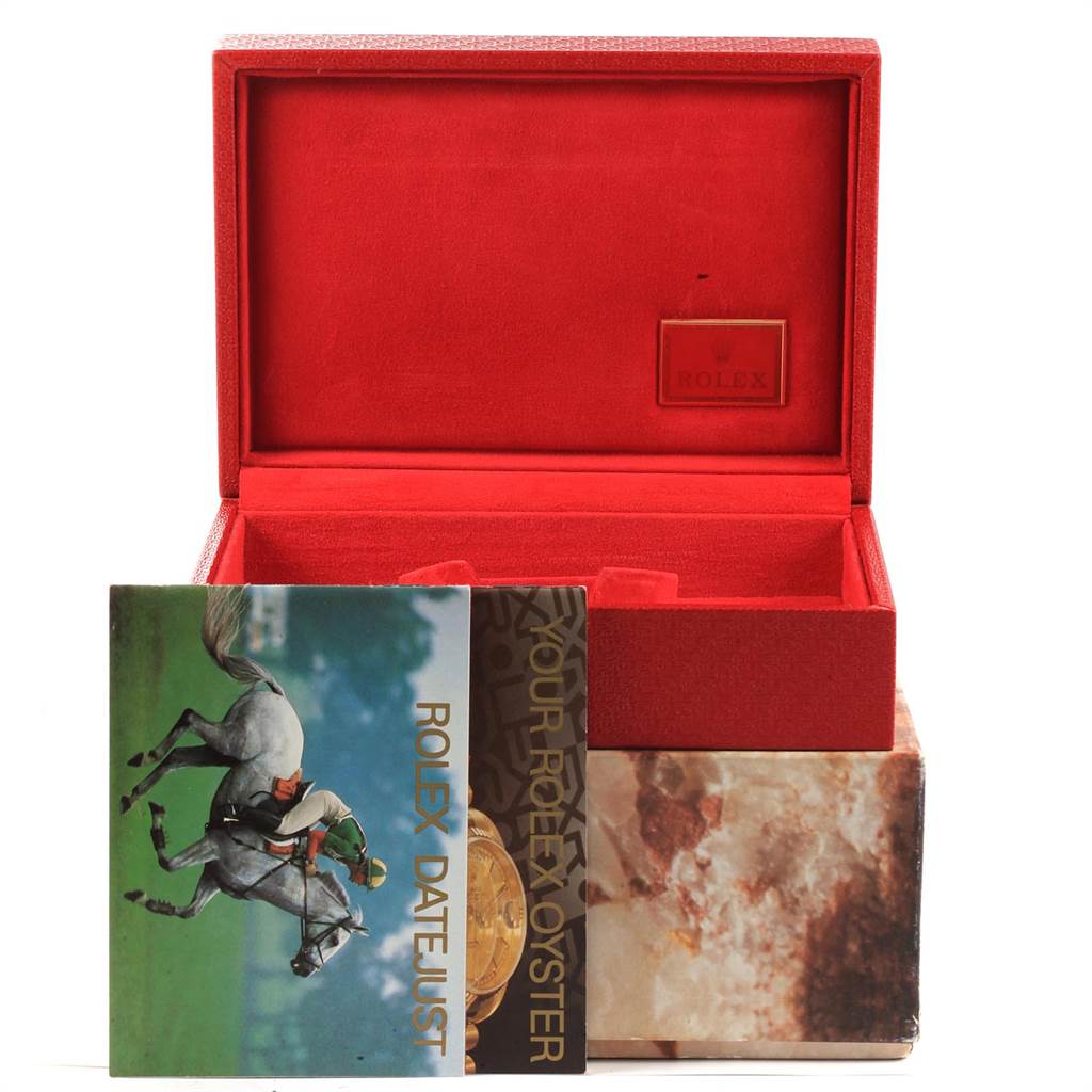 This image shows the interior of a Rolex President 69178 Women
s Yellow Gold Champagne Dial 69178 Women
s Yellow Gold Champagne Dial model
s red watch box and accompanying booklets from a front angle.