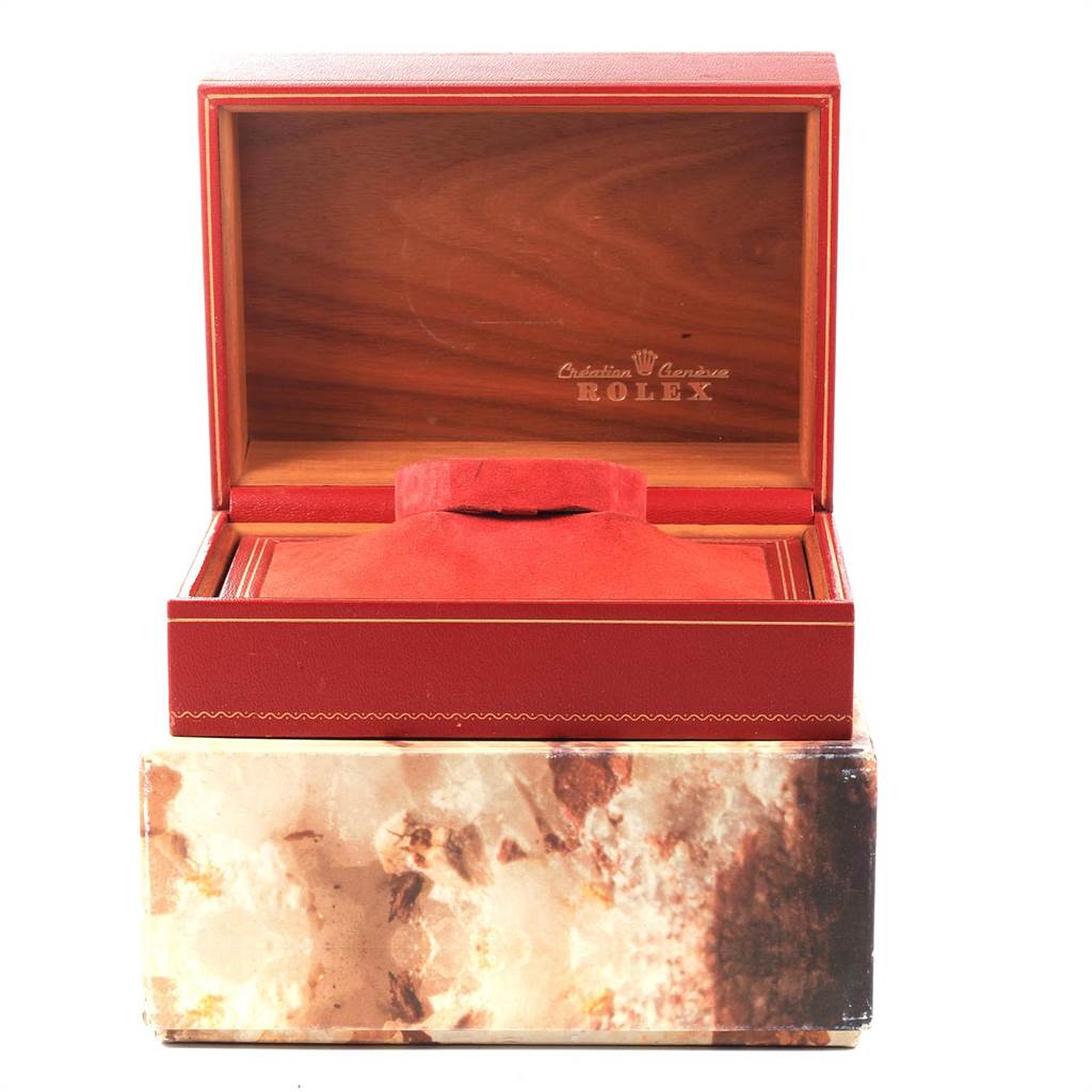 This image shows an open red and wooden box for the Rolex President 67198 Women
s Yellow Gold Champagne Dial 67198 Women
s Yellow Gold Champagne Dial model watch, with the outer decorative box beneath it.