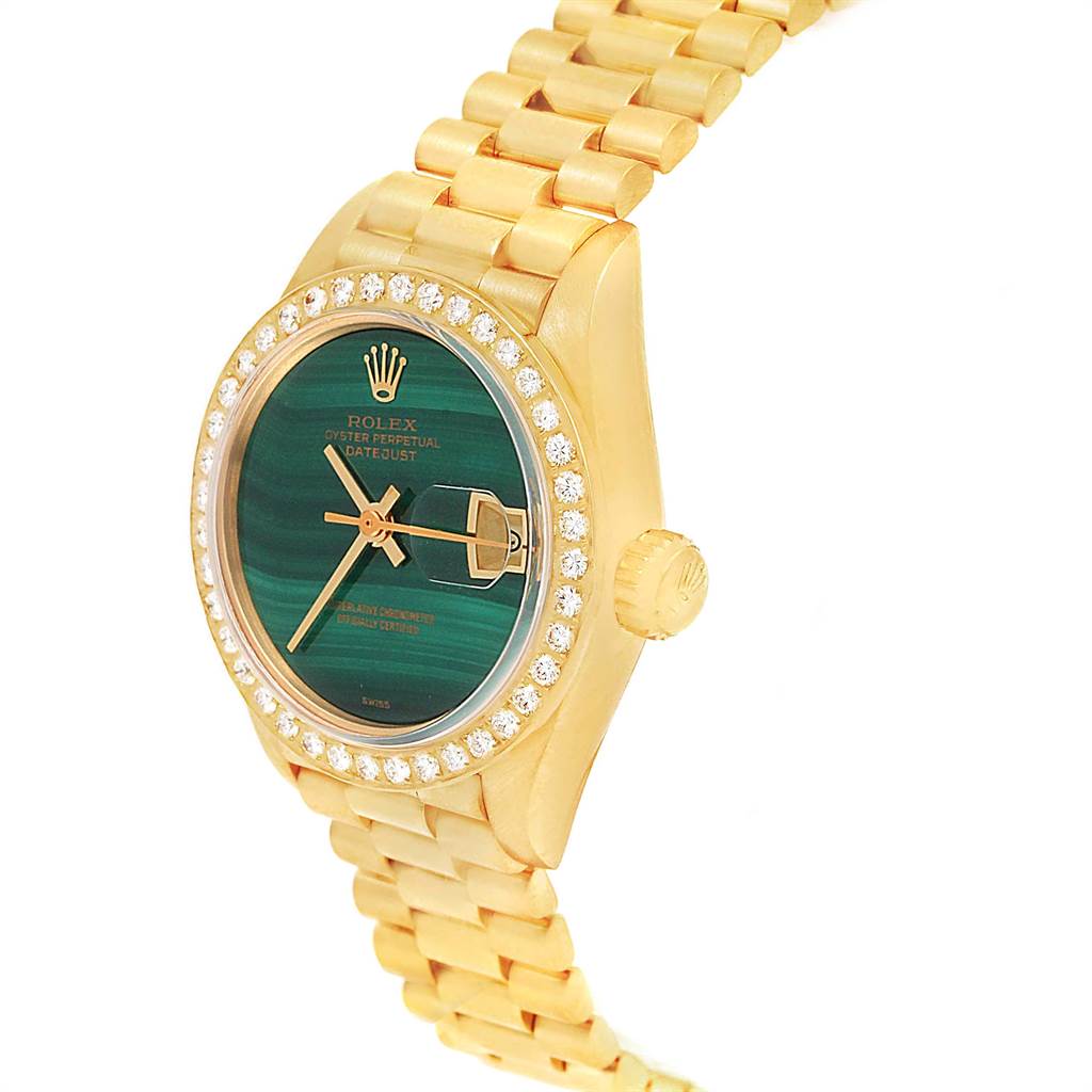 The image shows a Rolex President 69178 Women
s Yellow Gold Green Dial 69178 Women
s Yellow Gold Green Dial model watch from an angled side view, highlighting the diamond bezel, face, and crown.