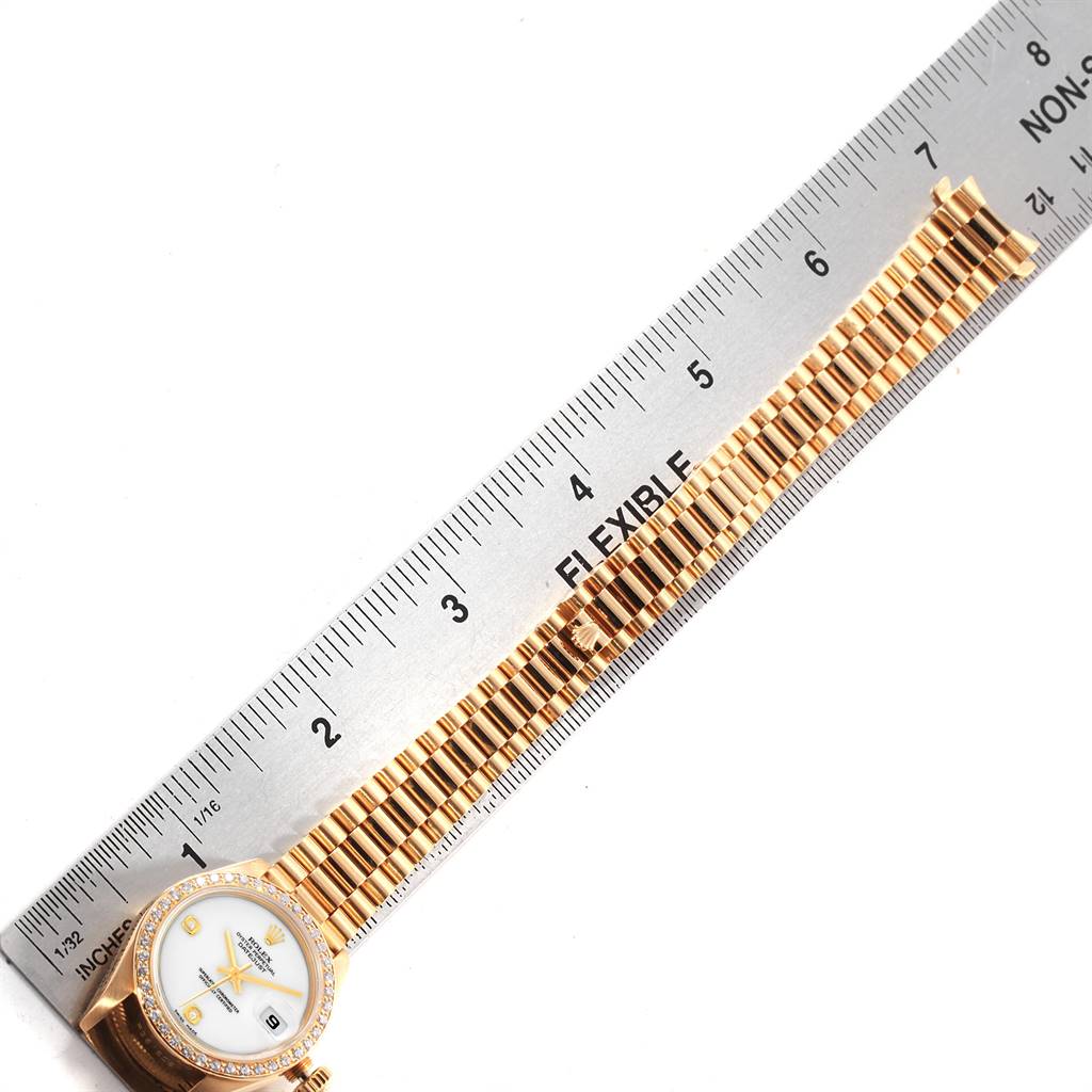 The Rolex President 69178 Women
s Yellow Gold Black Dial 69178 Women
s Yellow Gold Black Dial model watch is shown from a top-down angle, displaying the face and entire band alongside a measuring ruler.