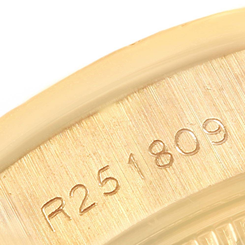 This close-up image of a Rolex President 69178 Women
s Yellow Gold Black Dial 69178 Women
s Yellow Gold Black Dial model watch shows the engraving on the inner bezel.