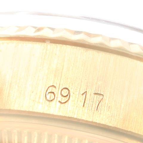 The image shows a close-up of the side of a Rolex President 6917 Women's Yellow Gold Champagne Dial 6917 Women's Yellow Gold Champagne Dial watch, highlighting the model number "6917" engraved on the metal.