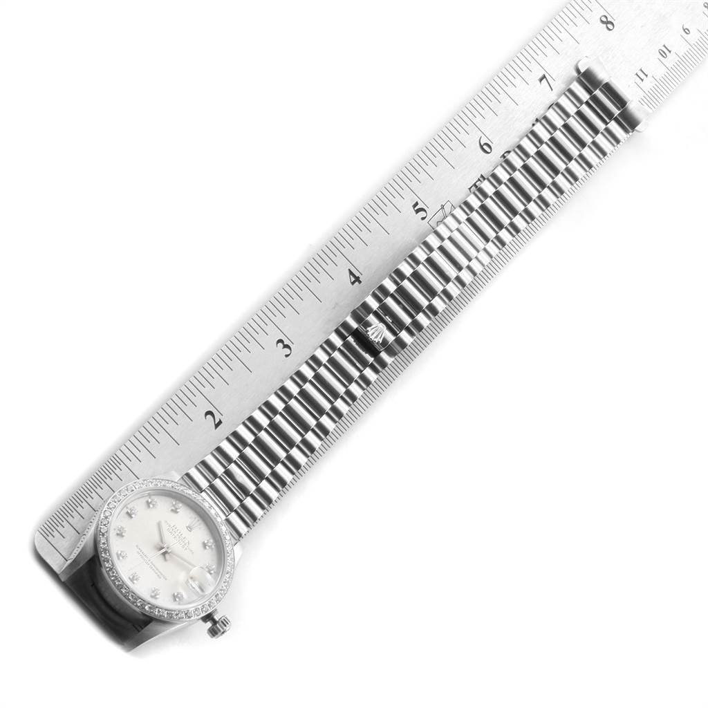 The image shows a top view of a Rolex President 68286 Women's Platinum Silver Dial 68286 Women's Platinum Silver Dial model watch, including its face and part of the band next to a ruler for measurement.