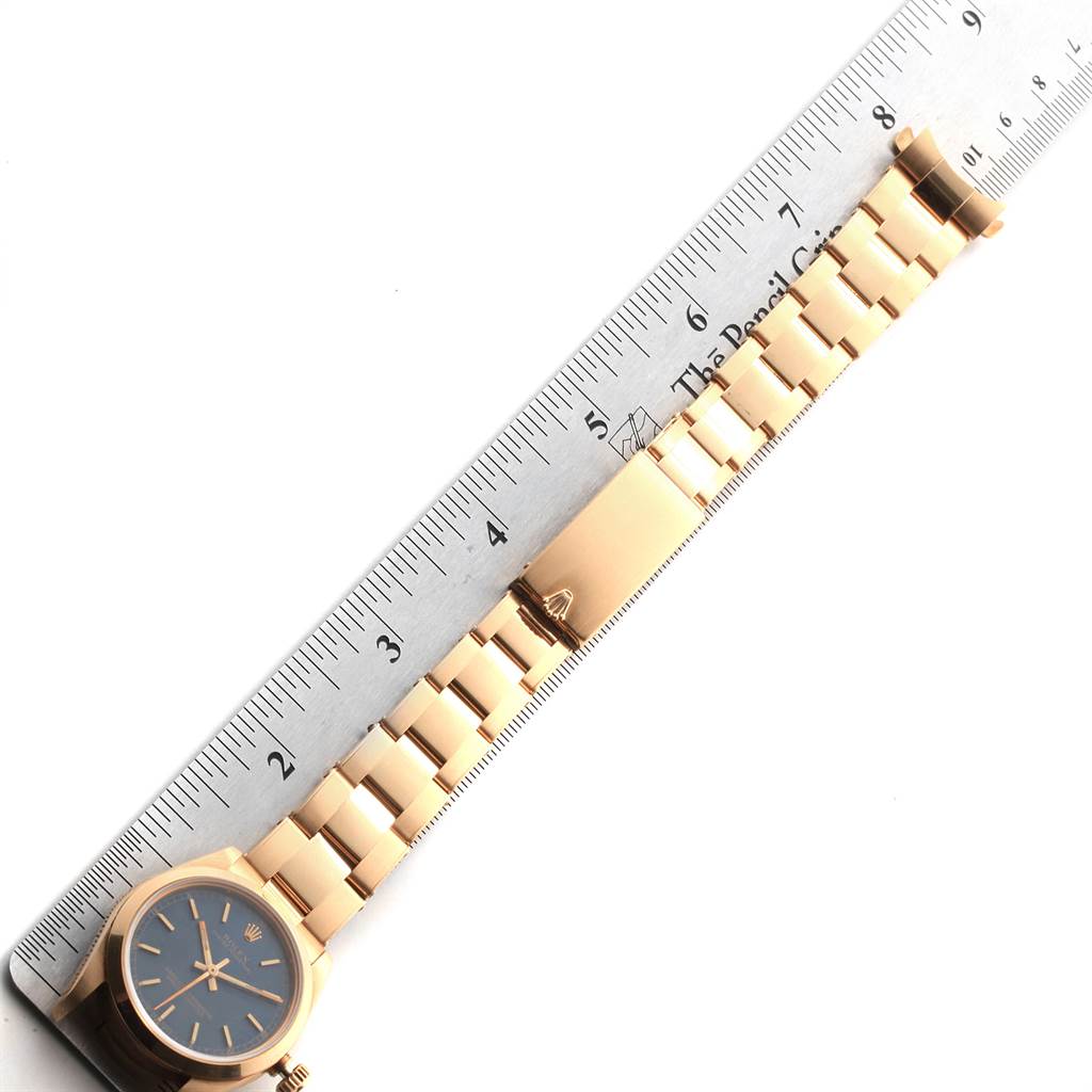 The image shows a Rolex President 67488 Women's Yellow Gold Blue Dial 67488 Women's Yellow Gold Blue Dial model lying flat next to a ruler, displaying the watch face, bracelet, and clasp.