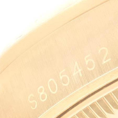 The image shows a close-up of the serial number on the case back of a Rolex President 67488 Women's Yellow Gold Blue Dial 67488 Women's Yellow Gold Blue Dial model.