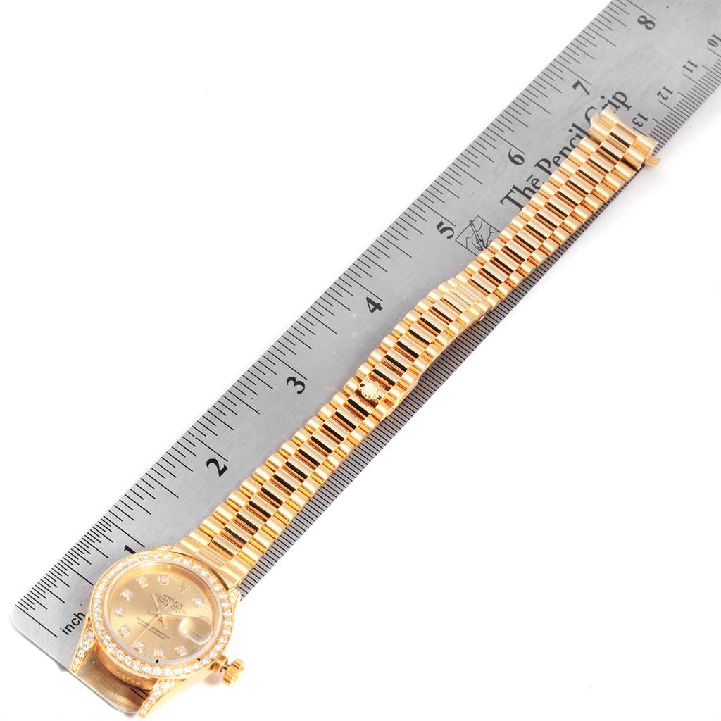The Rolex President 69158 Women
s Yellow Gold Champagne Dial 69158 Women
s Yellow Gold Champagne Dial model watch is shown from the top, displaying the dial, bezel, and bracelet alongside a ruler for size reference.