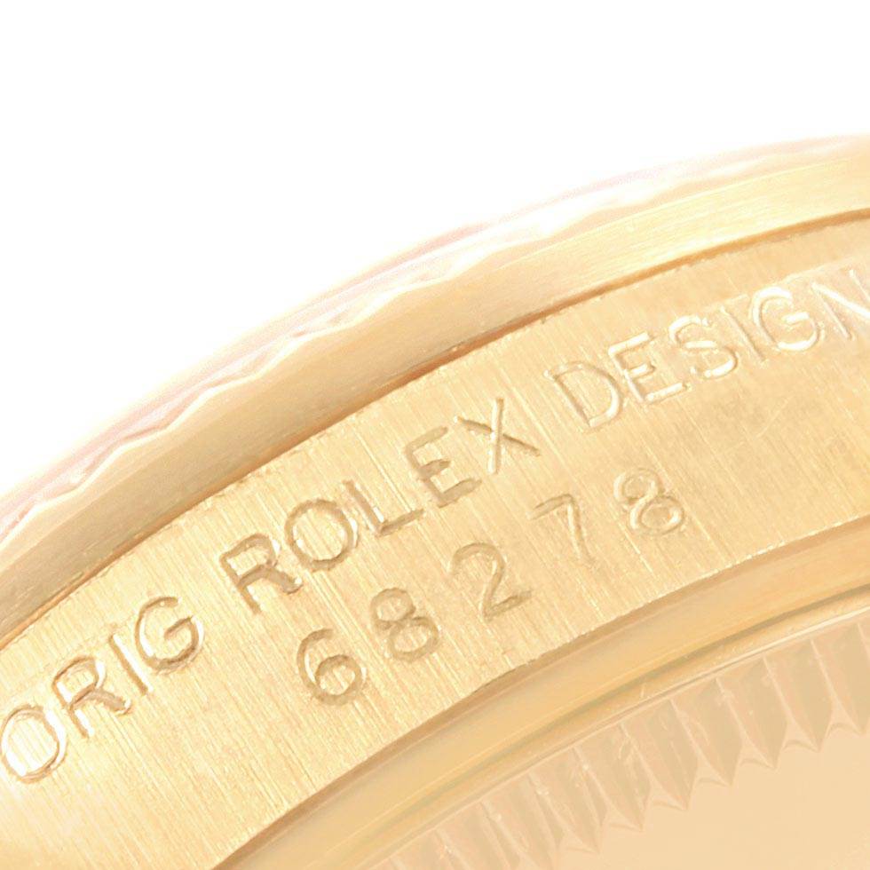 This image shows a close-up of the side bezel and case of a Rolex President 68278 Women's Yellow Gold Blue Dial 68278 Women's Yellow Gold Blue Dial model watch with the engraving visible.
