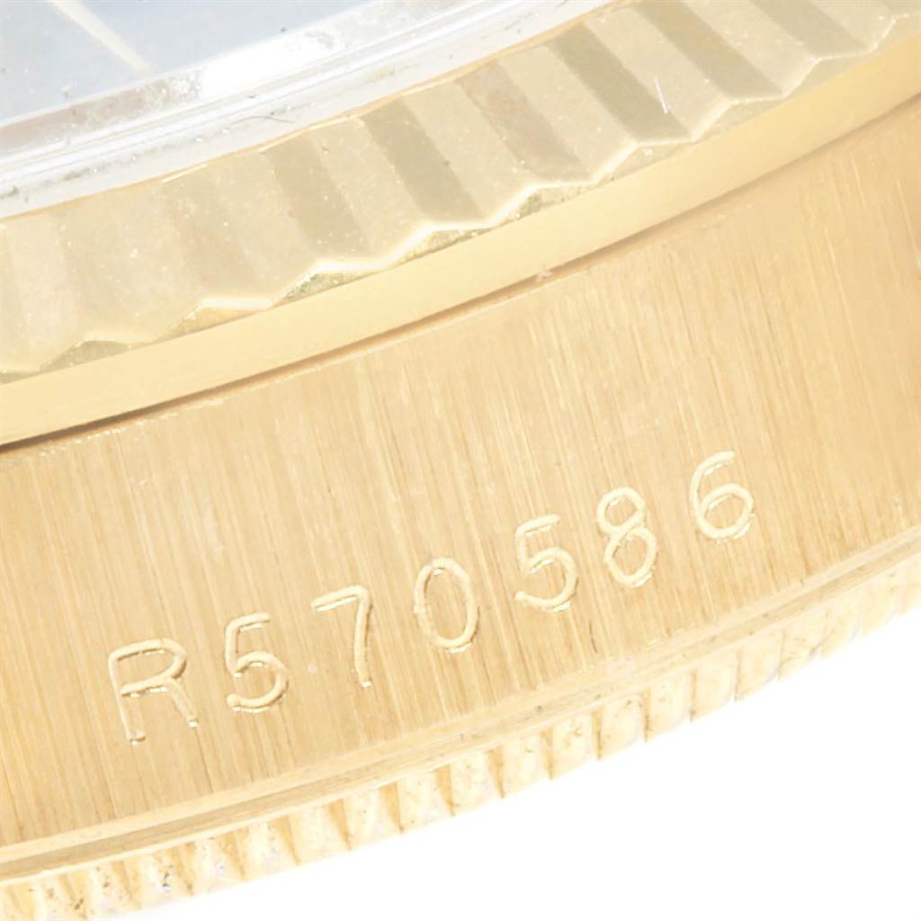 This close-up image shows the engraved serial number on the gold case of a Rolex President 68278 Women's Yellow Gold Blue Dial 68278 Women's Yellow Gold Blue Dial model watch.