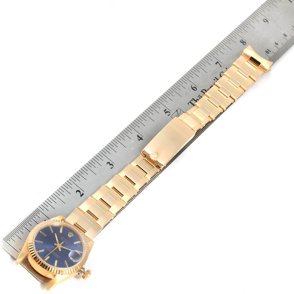 The image shows a Rolex President 68278 Women's Yellow Gold Blue Dial 68278 Women's Yellow Gold Blue Dial model watch fully extended with a ruler for scale, highlighting the bracelet and dial.