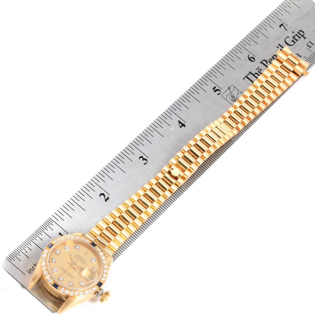 The Rolex President 69088 Women
s Yellow Gold Champagne Dial 69088 Women
s Yellow Gold Champagne Dial watch is shown from a top view, displaying the face, bezel, band, and ruler for scale.
