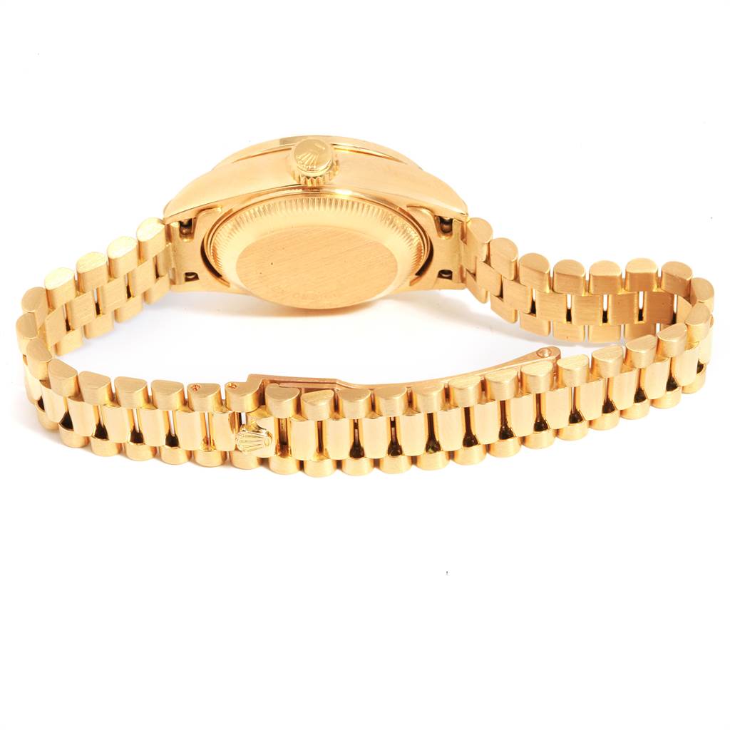The image shows the back case and part of the gold bracelet of a Rolex President 69088 Women
s Yellow Gold Champagne Dial 69088 Women
s Yellow Gold Champagne Dial model watch.