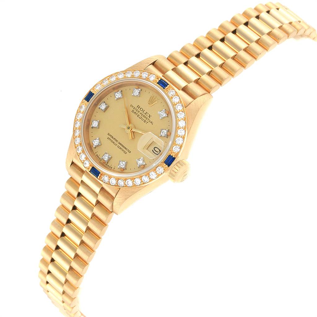 The image shows a Rolex President 69088 Women
s Yellow Gold Champagne Dial 69088 Women
s Yellow Gold Champagne Dial model watch at an angled view, highlighting its gold bracelet, diamond bezel, and champagne dial.