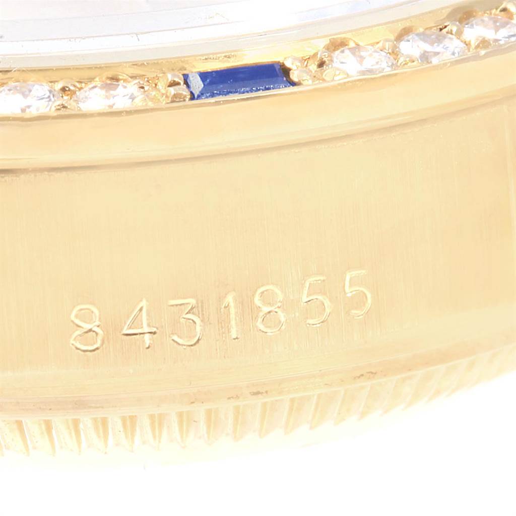 The image shows a close-up of the serial number and bezel with diamonds and sapphire accents on a Rolex President 69088 Women
s Yellow Gold Champagne Dial 69088 Women
s Yellow Gold Champagne Dial model watch.
