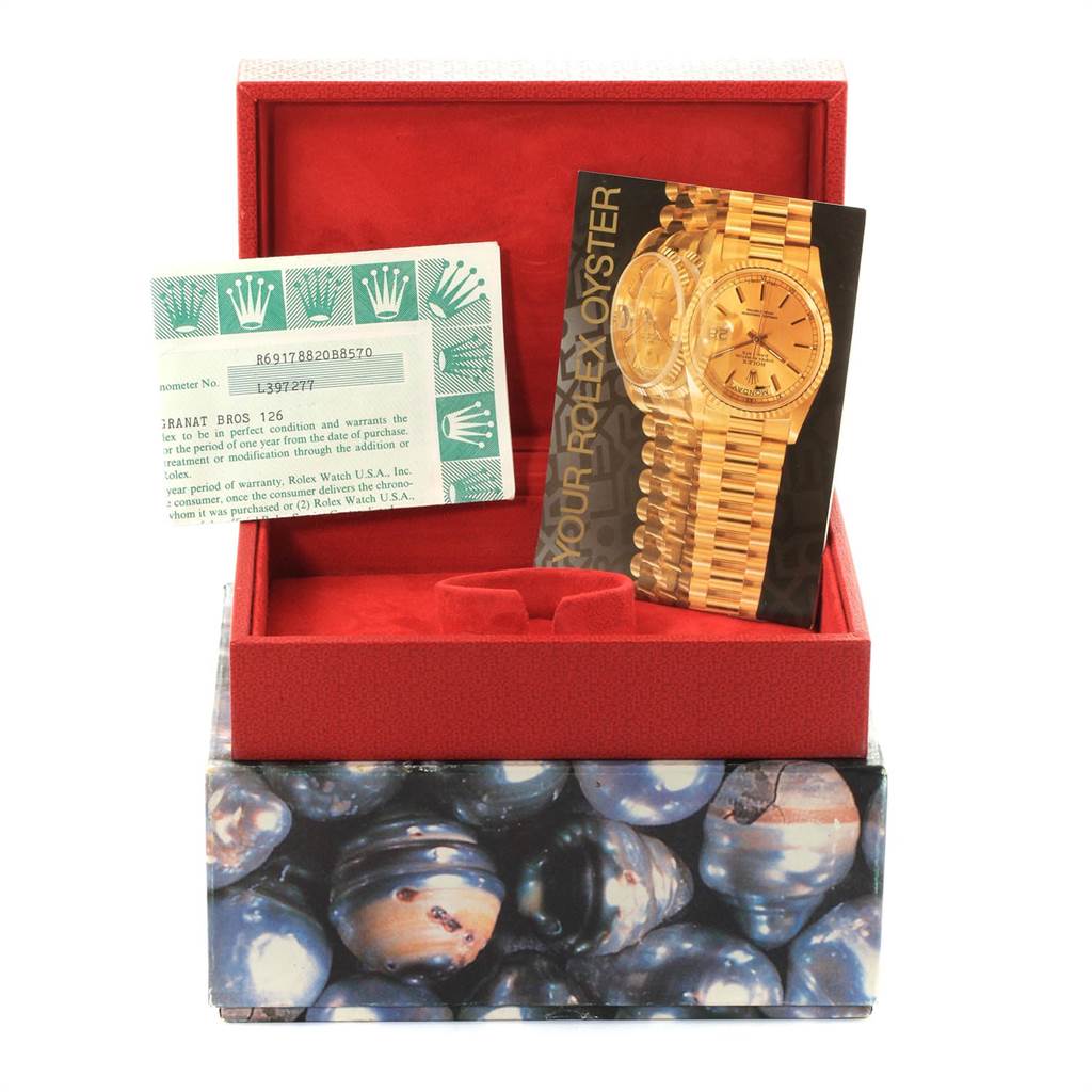 The image shows the box and papers for a Rolex President 69178 Women
s Yellow Gold Champagne Dial 69178 Women
s Yellow Gold Champagne Dial model watch, including the warranty card and a brochure.