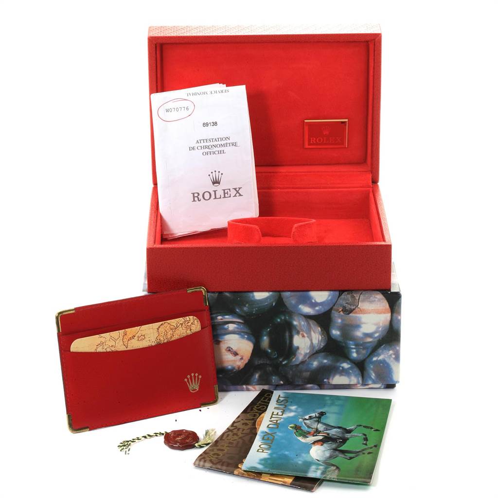 This image shows the packaging and accessories for a Rolex President 69138 Women
s Yellow Gold Champagne Dial 69138 Women
s Yellow Gold Champagne Dial watch, including a box, manual, and documentation.