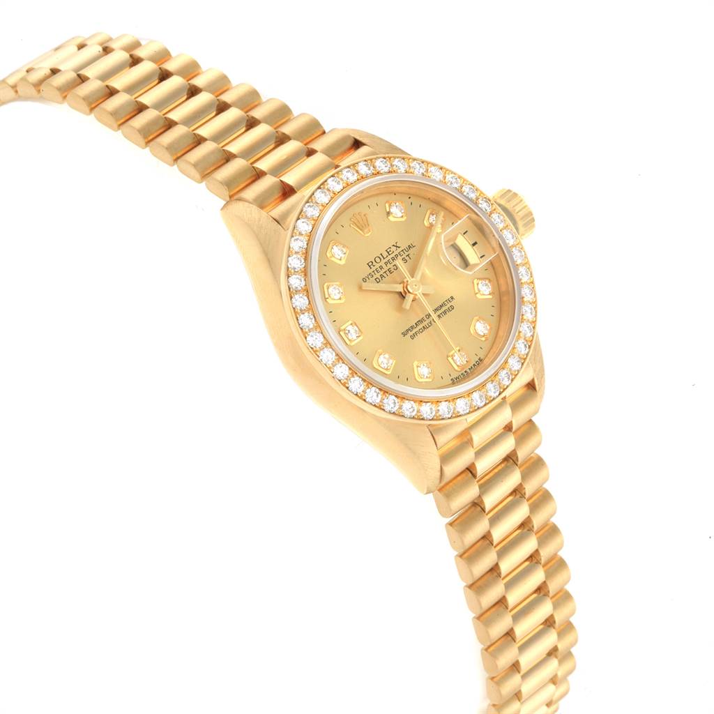 The image shows a side angle of the Rolex President 69138 Women
s Yellow Gold Champagne Dial 69138 Women
s Yellow Gold Champagne Dial model watch, highlighting its gold bracelet and diamond-set bezel and dial.