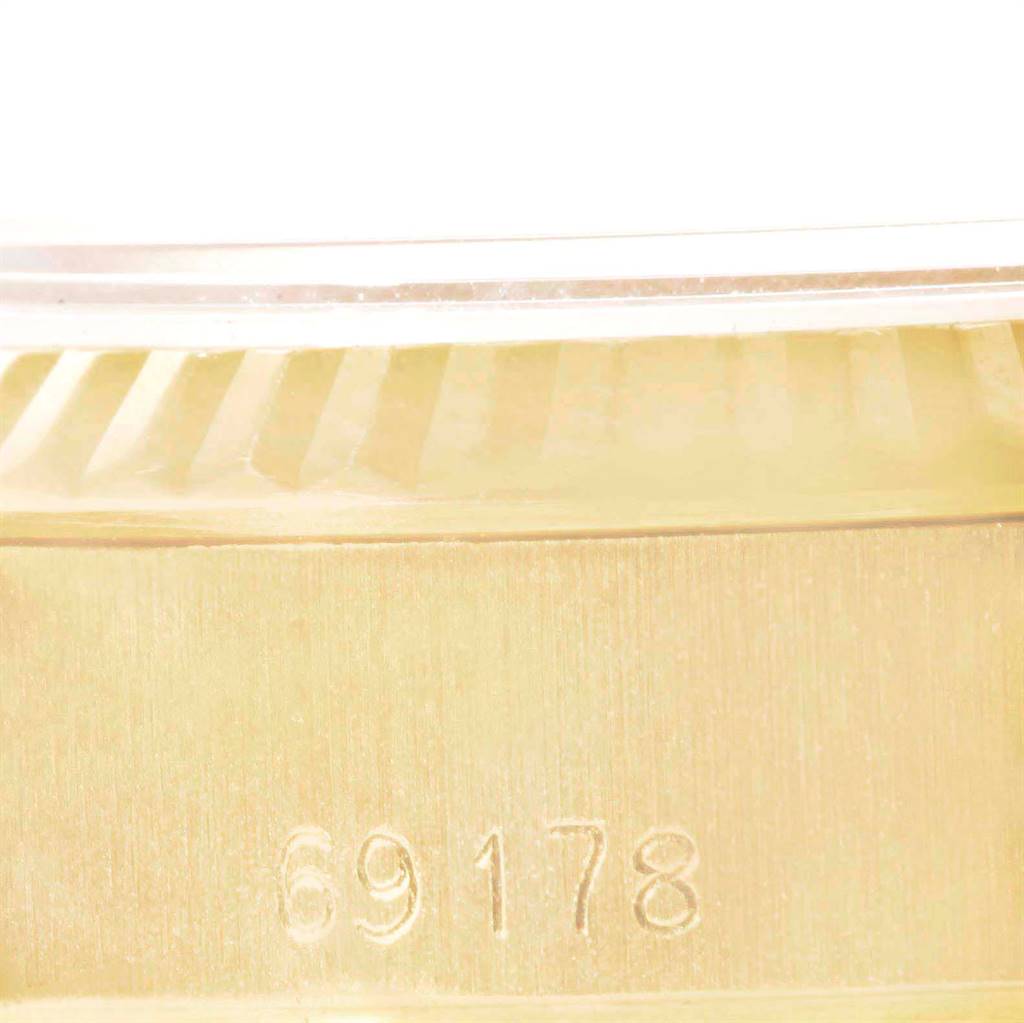 A close-up of the side of a Rolex President 69178 Women's Yellow Gold Black Dial 69178 Women's Yellow Gold Black Dial model watch, showing the model number 69178 and part of the bezel.