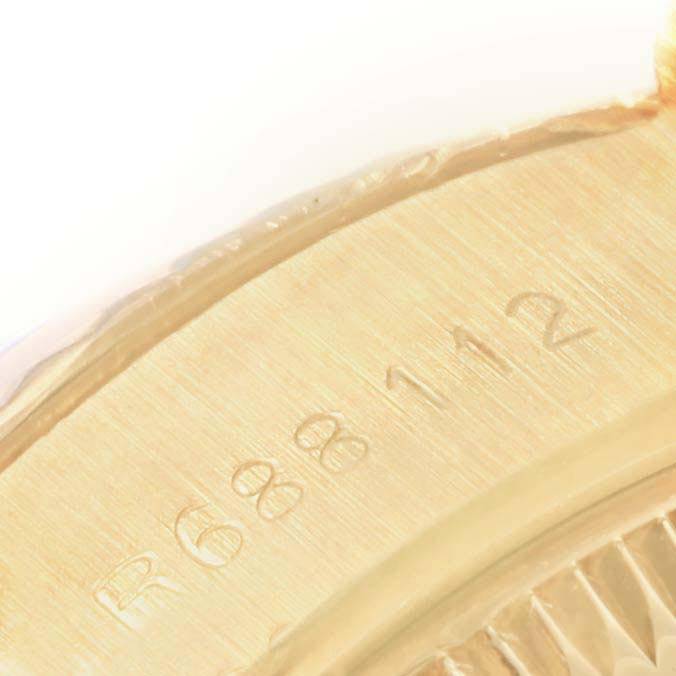 The image shows a close-up view of the engraved serial number on the case of a Rolex President 69178 Women's Yellow Gold Black Dial 69178 Women's Yellow Gold Black Dial watch.