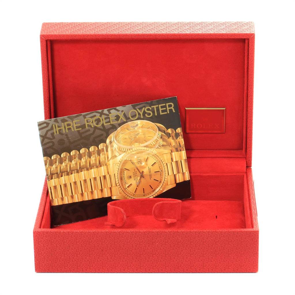 The image shows a Rolex President 69178 Women's Yellow Gold Black Dial 69178 Women's Yellow Gold Black Dial model watch box, an empty display cushion, and a booklet inside a red case.