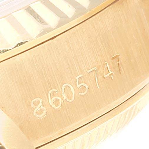 This close-up shows the serial number engraved on the gold case of a Rolex President 69178 Women's Yellow Gold Black Dial 69178 Women's Yellow Gold Black Dial model watch.